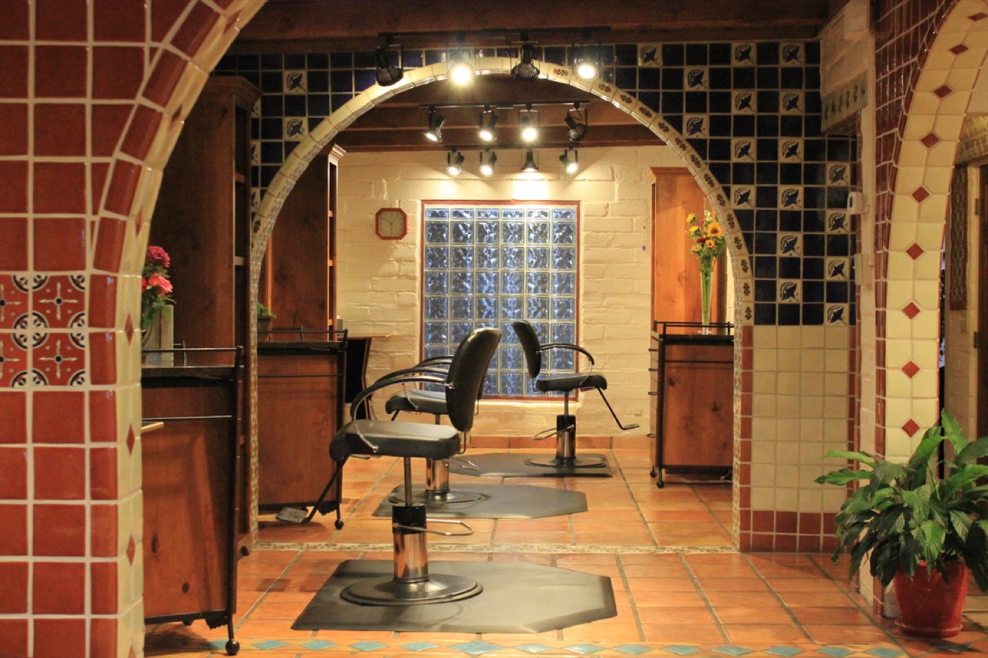 A tiled Southwest archway framing two styling chairs at Gloss Studio